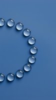 Clear water droplets arranged in curved line on blue background creating minimalist abstract composition for modern design projects.