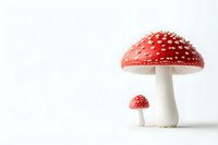 Red and white spotted mushroom amanita muscaria against white background, large and small toadstool composition with copy space for nature and fantasy designs.
