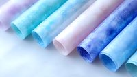 Rolled colorful gradient papers with sparkle effects in shades of blue, purple, and pink on white background, suitable for craft projects and design work.
