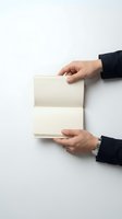 Business hands opening blank notebook on white background for corporate presentation and planning concepts.