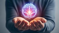 Glowing brain hologram floating above cupped hands representing artificial intelligence, mental health, neuroscience and cognitive technology concepts.