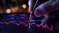 Hand holding pen pointing at financial chart with glowing pink and blue market data visualization on dark background with bokeh lights. Trading analysis concept.