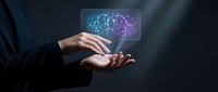 Businessman holding holographic brain with neural network connections representing artificial intelligence and machine learning technology concepts.