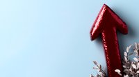 Red glittery arrow pointing upward against light blue background with decorative silver pine branches, symbolizing growth and success in business presentations.