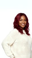 Happy African American woman with burgundy curly hair wearing cream knit sweater smiling on white background isolated for design use.
