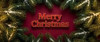 Merry Christmas greeting on deep red background framed by snow-dusted pine branches with warm glowing lights for holiday cards.