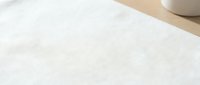 White linen fabric texture with natural weave pattern and soft lighting. Clean minimalist textile background for interior design and fashion projects.
