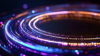 Glowing circular light trails with vibrant blue and purple neon colors against dark background create futuristic abstract pattern with bokeh effect.