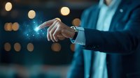 Businessman in suit touching glowing digital interface with finger, creating futuristic light effect against dark background with bokeh lights.