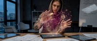 Young professional businesswoman interacting with futuristic holographic data visualization technology in modern office environment for digital innovation concepts.