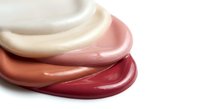 Creamy cosmetic swirls in pink and burgundy tones showcasing smooth texture and luxurious skincare product consistency for beauty and wellness applications.