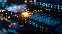 Glowing electronic microchip with sparks and bokeh lights in blue and orange tones, macro photography showing circuit board technology with defocused background.