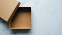 Open brown cardboard shipping box with lid on marble surface for packaging and delivery needs.