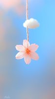 Delicate pink cherry blossom hanging from string with white cloud against soft blue sky background creates dreamy spring atmosphere.