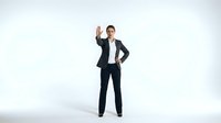 Professional businesswoman in dark suit making stop gesture with raised hand on white background for corporate presentations and business communications.