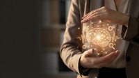 Businesswoman hands protecting glowing brain with network connections representing artificial intelligence and innovation in modern workplace.