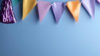 Festive party decoration with colorful triangle bunting flags and purple tassel against blue background. Copy space for celebration designs and party announcements.