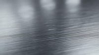 Brushed metal surface with fine linear texture and reflective finish, suitable for industrial backgrounds, technology designs, and modern material applications.