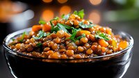 Spiced lentil curry with fresh herbs in glass bowl, healthy vegetarian protein dish with aromatic spices and garnish for nutritious meal preparation.