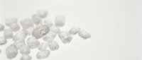 Clear quartz crystal chunks scattered on white background, isolated mineral specimens for design, jewelry, wellness, and educational content use.