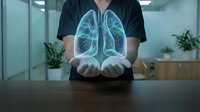 Healthcare professional displaying holographic lung anatomy model in modern medical office for respiratory system education and pulmonary health consultation.