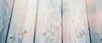 Weathered wooden planks with natural grain texture and rustic finish creating vintage background surface for product photography and design projects.