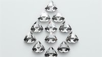 Clear sparkling diamonds arranged in triangular formation on light background, luxury gemstones with brilliant cut and high clarity for jewelry design concepts.