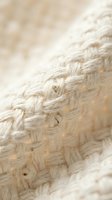 Natural jute rope texture with woven fibers in soft beige tones creating organic pattern for rustic craft and nautical design projects.