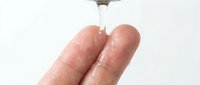 Hand sanitizer gel being dispensed onto clean fingers for hygiene and infection prevention in healthcare and daily life situations.