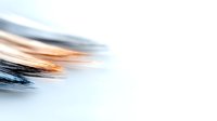 Abstract fluid art background with smooth blending of black and orange colors creating dynamic wave-like motion effect on white surface, suitable for modern design projects.