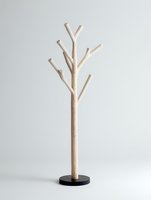 Minimalist wooden coat rack with natural branches on black base against neutral background for modern home organization and storage solutions.