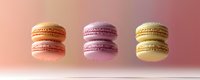 Colorful macarons floating against soft pink background, showcasing delicate texture and vibrant colors for food photography or dessert menu design.
