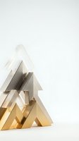 Stacked metallic tree shapes in white, gray, and gold tones arranged in ascending order on white background, suitable for holiday and festive design projects.