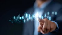 Professional in suit pointing at glowing digital human figures floating in dark space, representing human resources management and talent acquisition in corporate environment.