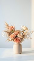 Elegant bouquet of peach roses and pampas grass in a beige ceramic vase on a white surface, soft neutral tones, boho style.