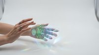 Caucasian woman's hand gesturing toward transparent robotic hand with glowing green and blue circuitry, representing artificial intelligence, technology innovation, and human-machine interaction for futuristic concepts.