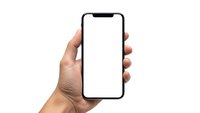 Hand holding modern smartphone with blank white screen isolated on white background for app presentation and mockup design.