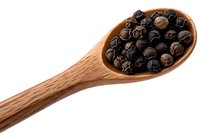 Whole black peppercorns in wooden spoon isolated on white background. Natural organic spice and seasoning ingredient for cooking and food preparation.
