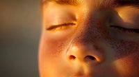 Close up portrait of young Asian woman with closed eyes in warm sunset light, peaceful serene expression showing mindfulness and tranquility. Perfect for wellness and meditation themes.