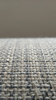 Close-up of neutral woven carpet texture with low pile construction, showing detailed fiber weave pattern. Suitable for interior design, flooring materials, home decor, and textile backgrounds.