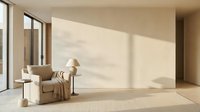 Minimalist living room interior with beige armchair and floor lamp in warm natural sunlight creating geometric shadows on neutral walls.