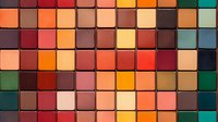 Colorful mosaic pattern of square tiles in warm earth tones, orange, red, brown and teal creating modern geometric abstract background. Seamless design for decoration.
