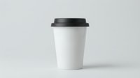 White disposable coffee cup with black lid isolated on gray background for branding mockup and cafe marketing materials.