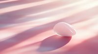 Smooth white pebble casting shadow on pink gradient background with diagonal light streaks. Minimalist zen composition for wellness and meditation concepts.