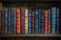 Row of vintage leather-bound books with ornate spines in blue, red, and gold on wooden shelf, creating classic library atmosphere. Perfect for education themes.