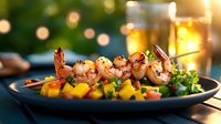 Grilled shrimp skewers with mango salsa on blue plate, garnished with fresh herbs against blurred outdoor setting with warm evening lights and drinks.