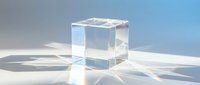 Transparent glass cube casting prismatic light reflections on a white surface, elegant geometric shape for product display or decoration.