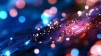 Macro view of electronic circuit board with glowing blue and red bokeh lights creating futuristic technology background pattern for digital concepts.