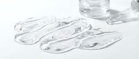 Transparent gel serum samples in clear petri dishes with water droplets, isolated on white background for cosmetic, skincare, and laboratory design use.