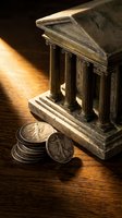 Miniature classical bank building model with ancient coins on wooden surface representing financial institutions and monetary systems for business concepts.